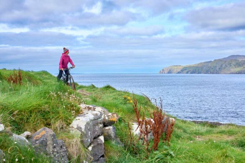 Woman-on-mountain-bike-cycling-cliffs-Dunmore head-Ireland (1)
